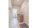 Hallway with laundry room and granite countertops near the entryway at 1669 Ludington Ave, Wesley Chapel, FL 33543