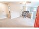 Cozy living room with two monitors on a desk and a vintage red refrigerator next to a doorway at 1669 Ludington Ave, Wesley Chapel, FL 33543