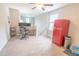 Cozy loft featuring two monitors on a desk, a colorful rolling cart, and a vintage red refrigerator at 1669 Ludington Ave, Wesley Chapel, FL 33543
