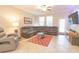 Comfortable living room featuring a large sectional sofa, tile floor, and natural light at 1669 Ludington Ave, Wesley Chapel, FL 33543
