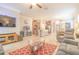 Open-concept living room featuring neutral walls, tile floors, ceiling fan, and a comfortable gray sofa at 1669 Ludington Ave, Wesley Chapel, FL 33543