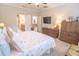 Bright main bedroom boasts a ceiling fan, TV, and ensuite bathroom at 1669 Ludington Ave, Wesley Chapel, FL 33543