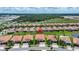Aerial view of a community with well-manicured lawns and barrel tile roofs at 16938 Scuba Crest St, Wimauma, FL 33598