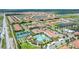 Community aerial view featuring pool, tennis courts, clubhouse, and surrounding homes and lakes at 16938 Scuba Crest St, Wimauma, FL 33598