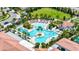 Aerial view of a resort-style pool surrounded by lush landscaping and ample seating areas at 16938 Scuba Crest St, Wimauma, FL 33598