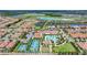Expansive aerial view of the community showcasing the pool, tennis courts, lush landscaping, and well-maintained homes at 16938 Scuba Crest St, Wimauma, FL 33598