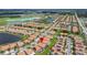 Expansive aerial view of a community with beautiful homes, lakes, and resort-style amenities at 16938 Scuba Crest St, Wimauma, FL 33598