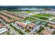 Aerial view of community clubhouse, pool and tennis courts in a neighborhood at 16938 Scuba Crest St, Wimauma, FL 33598