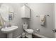 Powder room offers pedestal sink, matching fixtures and a decorative mirror at 16938 Scuba Crest St, Wimauma, FL 33598