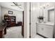 Home office featuring a view to attached powder room with a white vanity at 16938 Scuba Crest St, Wimauma, FL 33598