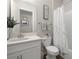 Bathroom featuring a white vanity, marble-style shower curtain, and coordinating decor at 16938 Scuba Crest St, Wimauma, FL 33598