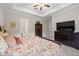 Cozy bedroom with a decorative valance and a dark wood dresser with TV at 16938 Scuba Crest St, Wimauma, FL 33598