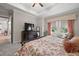 Comfortable bedroom featuring tray ceilings, neutral walls, and soft carpeting at 16938 Scuba Crest St, Wimauma, FL 33598