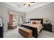 Elegant bedroom features tray ceilings, a decorative valance, and neutral carpeting at 16938 Scuba Crest St, Wimauma, FL 33598