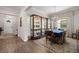 Elegant dining room features a designer chandelier, wood-look floors, and a beautiful display cabinet at 16938 Scuba Crest St, Wimauma, FL 33598
