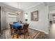 Elegant dining room features a designer chandelier, wood-look floors, and ample light at 16938 Scuba Crest St, Wimauma, FL 33598