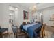 Elegant dining room features a designer chandelier and wood-look floors at 16938 Scuba Crest St, Wimauma, FL 33598
