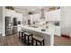 Modern kitchen features a center island, stainless appliances, and custom white cabinetry at 16938 Scuba Crest St, Wimauma, FL 33598