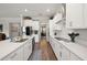 Bright kitchen features stainless appliances, custom white cabinetry, and a center island with counter seating at 16938 Scuba Crest St, Wimauma, FL 33598