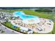 Aerial view of a pristine blue lagoon, beach club, recreational facilities and sunbathing beach at 16938 Scuba Crest St, Wimauma, FL 33598