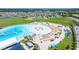 Community lagoon with swimming areas, sandy beach, seating, waterslides, and rentable sun-shades at 16938 Scuba Crest St, Wimauma, FL 33598
