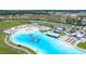 Stunning aerial view of community lagoon with sandy beach area, swimming zones, and watersport rentals at 16938 Scuba Crest St, Wimauma, FL 33598