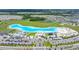 Aerial shot showcases a community lagoon surrounded by residences, offering a vibrant outdoor recreation area at 16938 Scuba Crest St, Wimauma, FL 33598