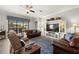 Spacious living room with a large entertainment center and comfortable leather seating at 16938 Scuba Crest St, Wimauma, FL 33598