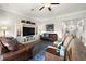 Inviting living room with hardwood floors, comfortable seating, and a built-in entertainment center at 16938 Scuba Crest St, Wimauma, FL 33598