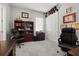 Home office with neutral carpet flooring, large bookcase, and dual desk spaces at 16938 Scuba Crest St, Wimauma, FL 33598