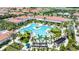 Aerial view of a resort-style community pool with palm trees, lounge chairs, and inviting clear blue water at 16938 Scuba Crest St, Wimauma, FL 33598