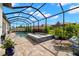 A screened in pool with a spa at 16938 Scuba Crest St, Wimauma, FL 33598
