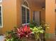 Charming front porch features neutral colors and flourishing plants at 1855 Briland St, Tarpon Springs, FL 34689