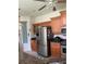 Well-lit kitchen with stainless steel refrigerator and light wood cabinets at 1855 Briland St, Tarpon Springs, FL 34689