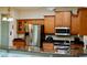 This kitchen features stainless steel appliances, granite countertops and wooden cabinets at 1855 Briland St, Tarpon Springs, FL 34689
