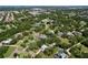 Aerial view of a residential neighborhood with mature trees and well-maintained homes at 1861 Royal Oak E Pl, Dunedin, FL 34698