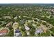 Overhead shot of a neighborhood with mature trees and various home styles at 1861 Royal Oak E Pl, Dunedin, FL 34698