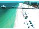 Overhead view of a pristine beach with white sand, clear turquoise water, and a pier extending into the ocean at 1861 Royal Oak E Pl, Dunedin, FL 34698