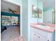 Bathroom featuring a sink and a doorway to the bedroom at 1861 Royal Oak E Pl, Dunedin, FL 34698