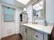 Bathroom featuring marble countertops and a door to the outside at 1861 Royal Oak E Pl, Dunedin, FL 34698
