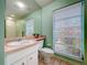 Bathroom with a wide window letting in lots of natural light at 1861 Royal Oak E Pl, Dunedin, FL 34698