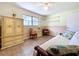 Inviting bedroom featuring tile floors, a ceiling fan, and bright natural light at 1861 Royal Oak E Pl, Dunedin, FL 34698