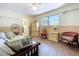 Charming bedroom with tile flooring, complemented by a ceiling fan, classic furniture and ample natural light at 1861 Royal Oak E Pl, Dunedin, FL 34698