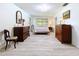 Bedroom featuring wood look floors, bright natural light, and ample space at 1861 Royal Oak E Pl, Dunedin, FL 34698