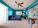Bedroom with large windows, ceiling fan and patterned bedspread at 1861 Royal Oak E Pl, Dunedin, FL 34698