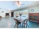 Open-plan dining area with views of the pool area and sliding doors at 1861 Royal Oak E Pl, Dunedin, FL 34698