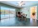 Dining area with table, chairs, tile floor and view of the screened pool at 1861 Royal Oak E Pl, Dunedin, FL 34698
