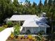 A nicely landscaped single-story home with mature trees at 1861 Royal Oak E Pl, Dunedin, FL 34698