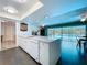 Kitchen with granite countertops and views of the dining area and pool at 1861 Royal Oak E Pl, Dunedin, FL 34698