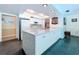 Bright kitchen featuring granite countertops and white cabinetry at 1861 Royal Oak E Pl, Dunedin, FL 34698